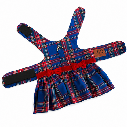 A blue tartan plaid pet harness dress with a red waist belt and bow, displayed flat on a white background.
