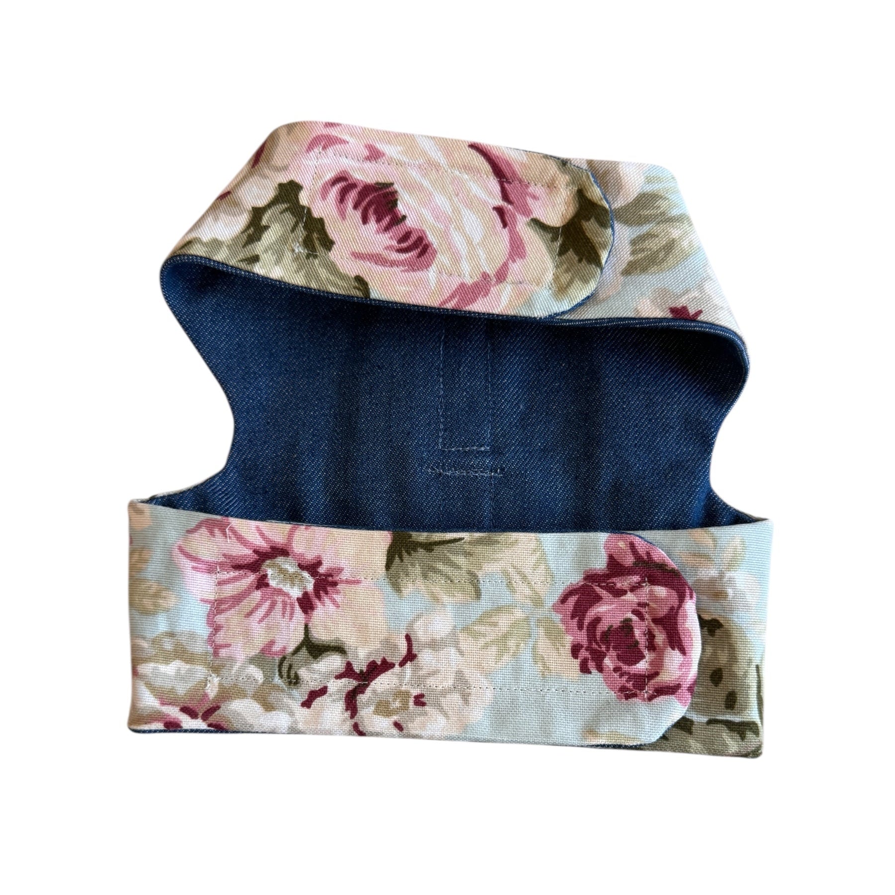 Floral-patterned dog coat with a blue base on a white background