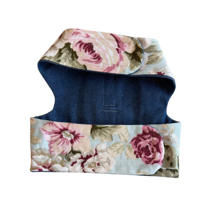 Floral-patterned dog coat with a blue base on a white background
