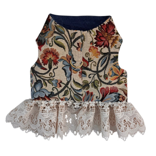 Floral patterned dog harness with lace trim on a white background