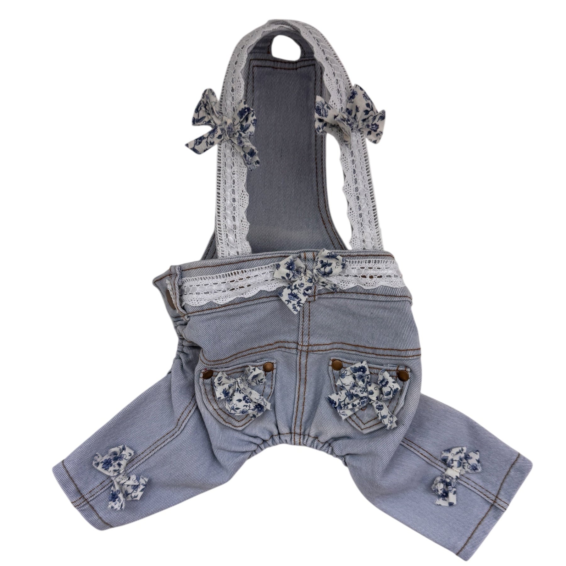 Denim dog overalls with lace details on a white background
