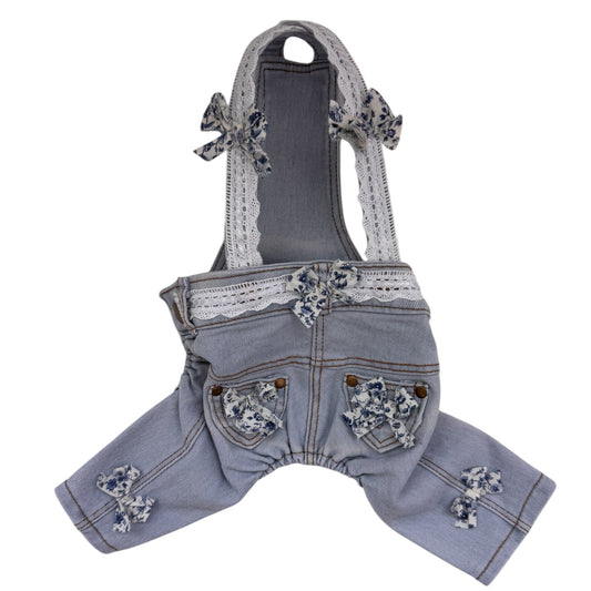 Denim dog overalls with lace details on a white background