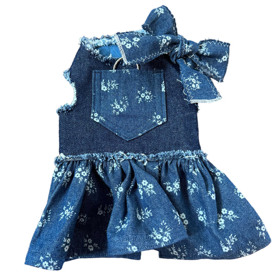 Blue floral dress with ruffled details on a white surface