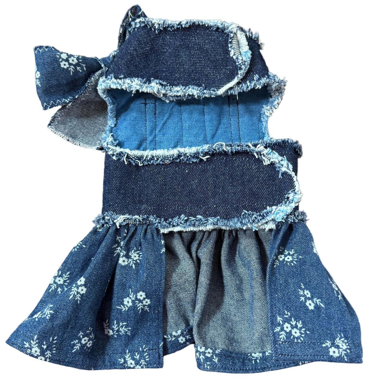Blue denim bow with floral patterns on a white surface
