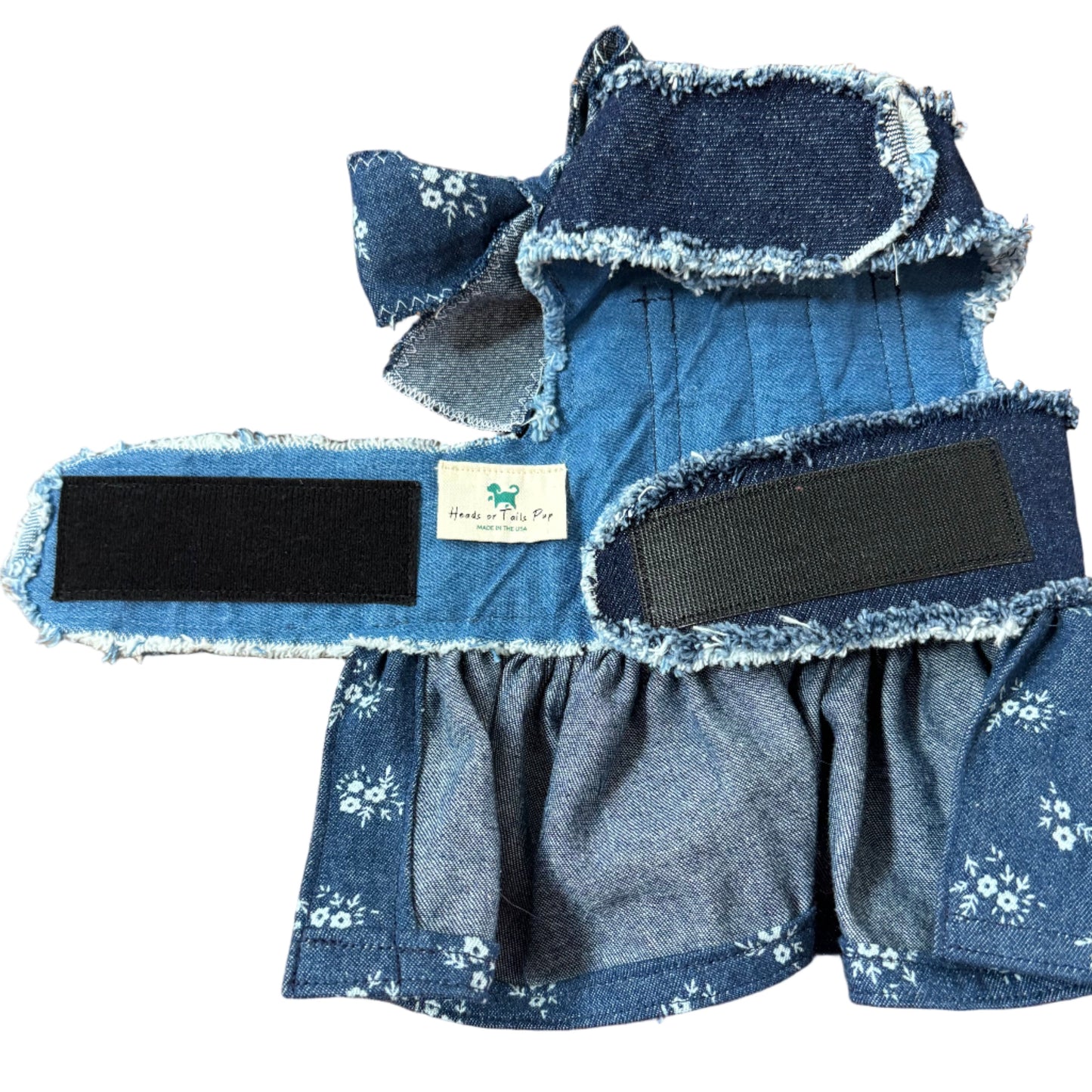 Blue denim product with floral patterns on a white surface