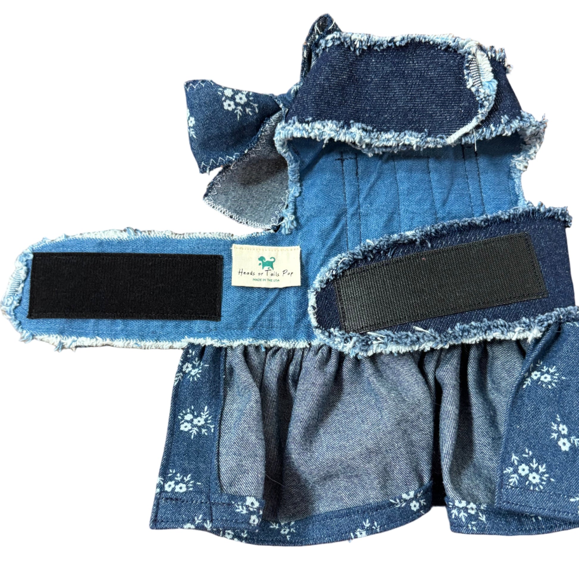 Blue denim product with floral patterns on a white surface