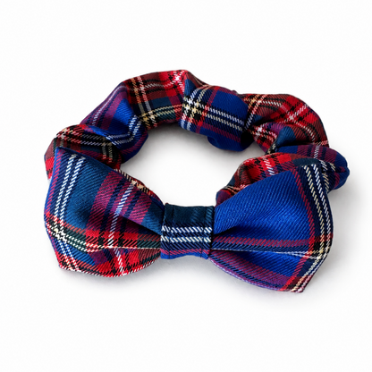 A plaid bow tie scrunchie collar in a classic tartan pattern of red, navy blue, white, and black, shown on a clean white background.
