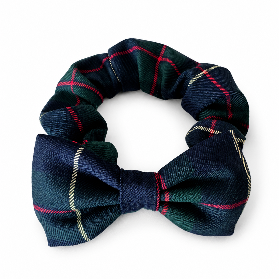 A small bow tie scrunchie pet collar in a dark navy blue tartan plaid fabric with red and gold stripes, shown on a plain white background.