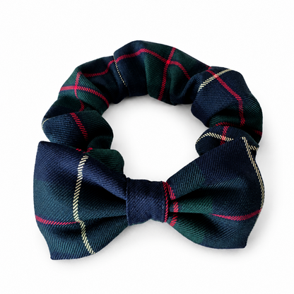 A small bow tie scrunchie pet collar in a dark navy blue tartan plaid fabric with red and gold stripes, shown on a plain white background.
