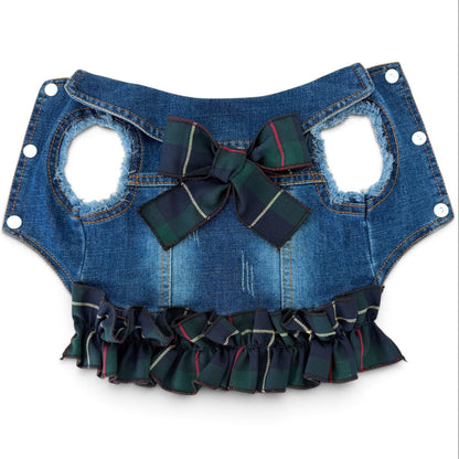 A blue denim pet vest with a large green plaid bow at the center, and a matching ruffled trim along the bottom edge, shown against a plain white background.