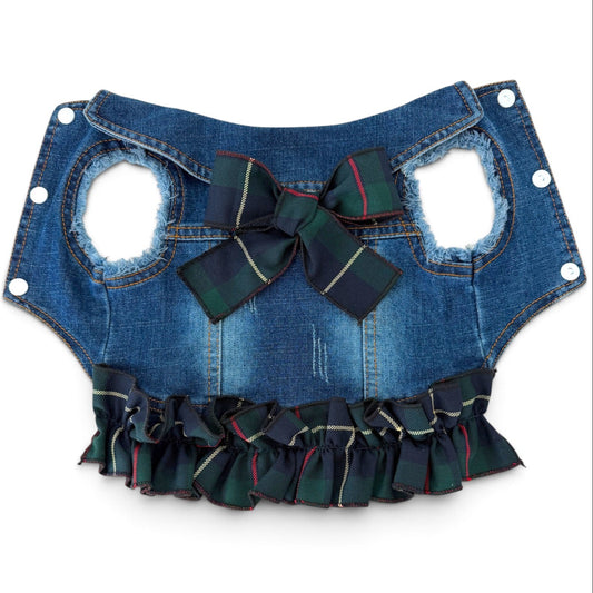 A blue denim pet vest with a large green plaid bow at the center, and a matching ruffled trim along the bottom edge, shown against a plain white background.