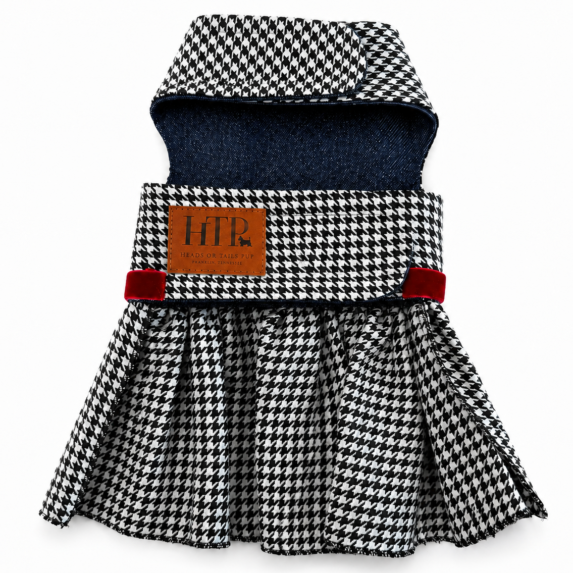 A pet dress with a black and white houndstooth pattern, a dark blue denim inner lining, and red velvet side accents, featuring a brown leather patch with 'HTP', set against a plain white background.