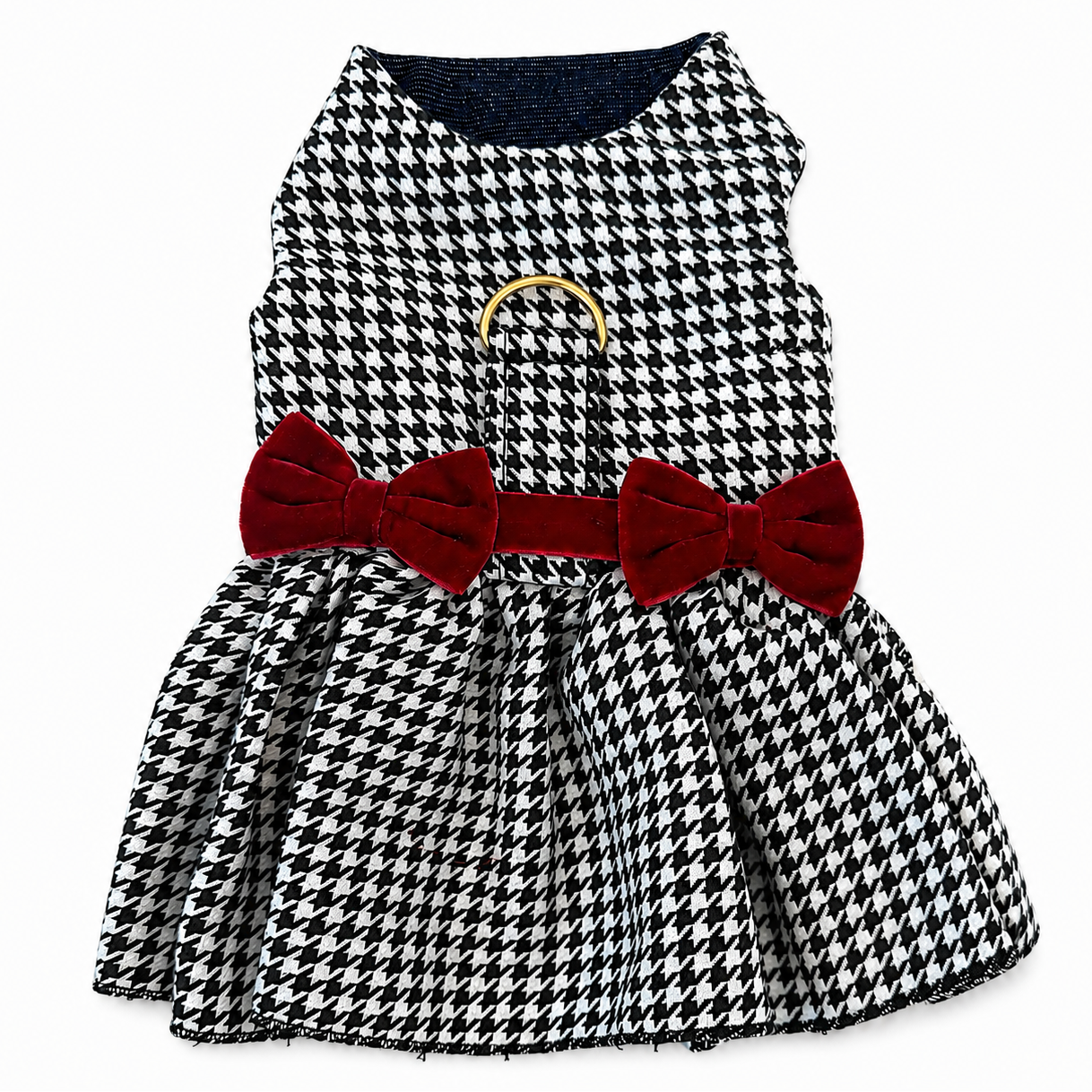 A sleeveless black and white houndstooth dress for dog, featuring a red velvet bow belt with a gold ring accent at the waist and a navy blue denim lining.